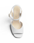 Vista superior de zapatilla para dama blanca con punta abierta pulsera ajustable al tobillo y plataforma tacón alto 12cm