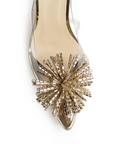 Vista de material sintético en zapatilla dorada transparente destalonada para mujer con pedrería en punta fina tipo stiletto y tacón delgado de 9cm