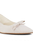 detalle del material sintético en zapatillas beige con moño para dama