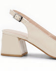 vista trasera del tacón bajo 6 cm en las zapatillas de charol beige para dama destalonadas