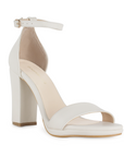 Vista diagonal de zapatilla beige con tacón tipo bloque de 10cm y pulsera para mujer
