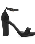 Vista lateral de zapatilla negra en acabado cabra sintético con pulsera y tacón medio de 10cm para mujer