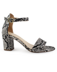 Vista lateral de zapatilla negra con beige para mujer con pulsera y tacón bajo