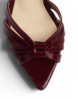 Vista del detalle del charol en zapatilla vino de tacon para mujer