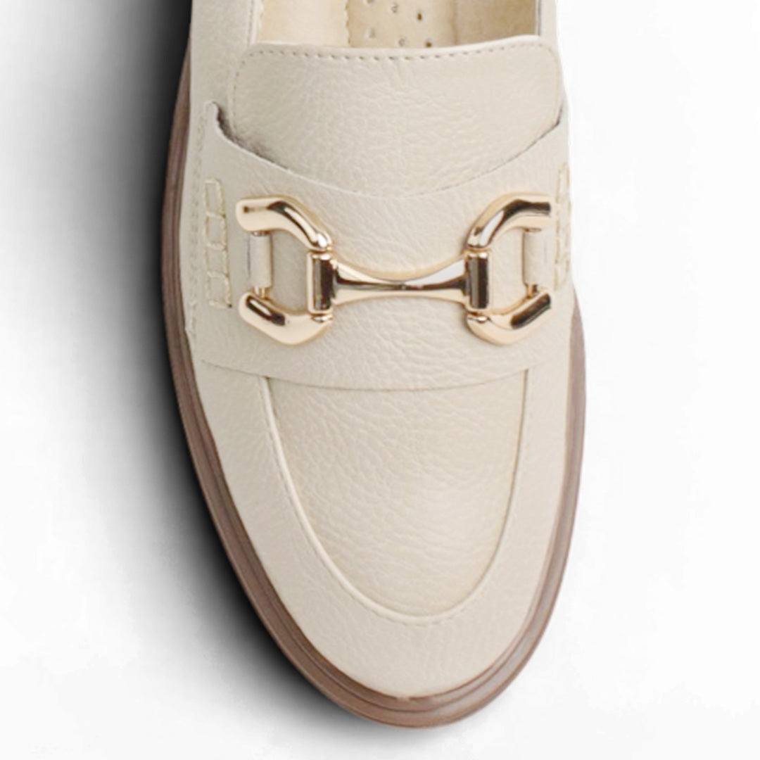 Vista de material sintético en mocasín beige de meter para mujer con tacón bajo de 3cm y herraje decorativo