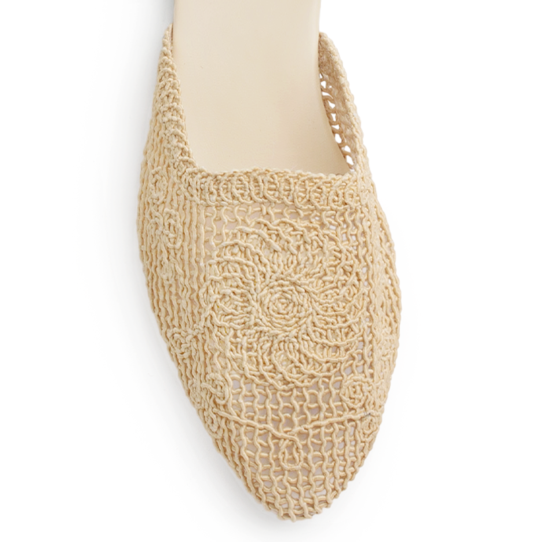 Vista de material sintético en flats beige de piso para mujer con punta perforada fina tipo mules destalonadas
