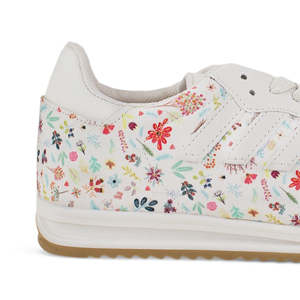 Vista trasera de la suela baja 2cm del tenis beige para dama con diseño floral y punta gris