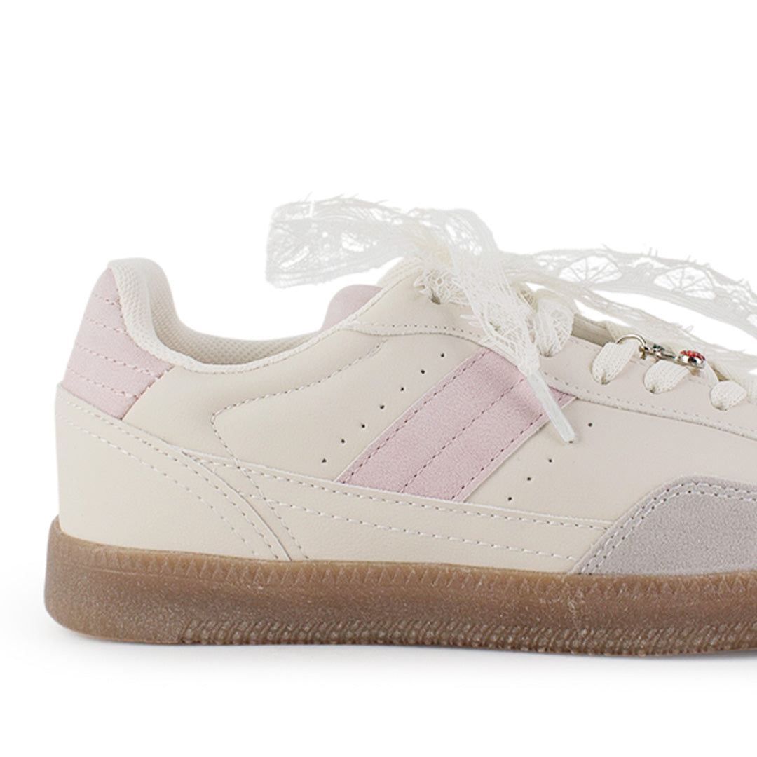 Vista trasera de suela baja en tenis beige con rosa para mujer con ajuste de agujetas y colgante 
