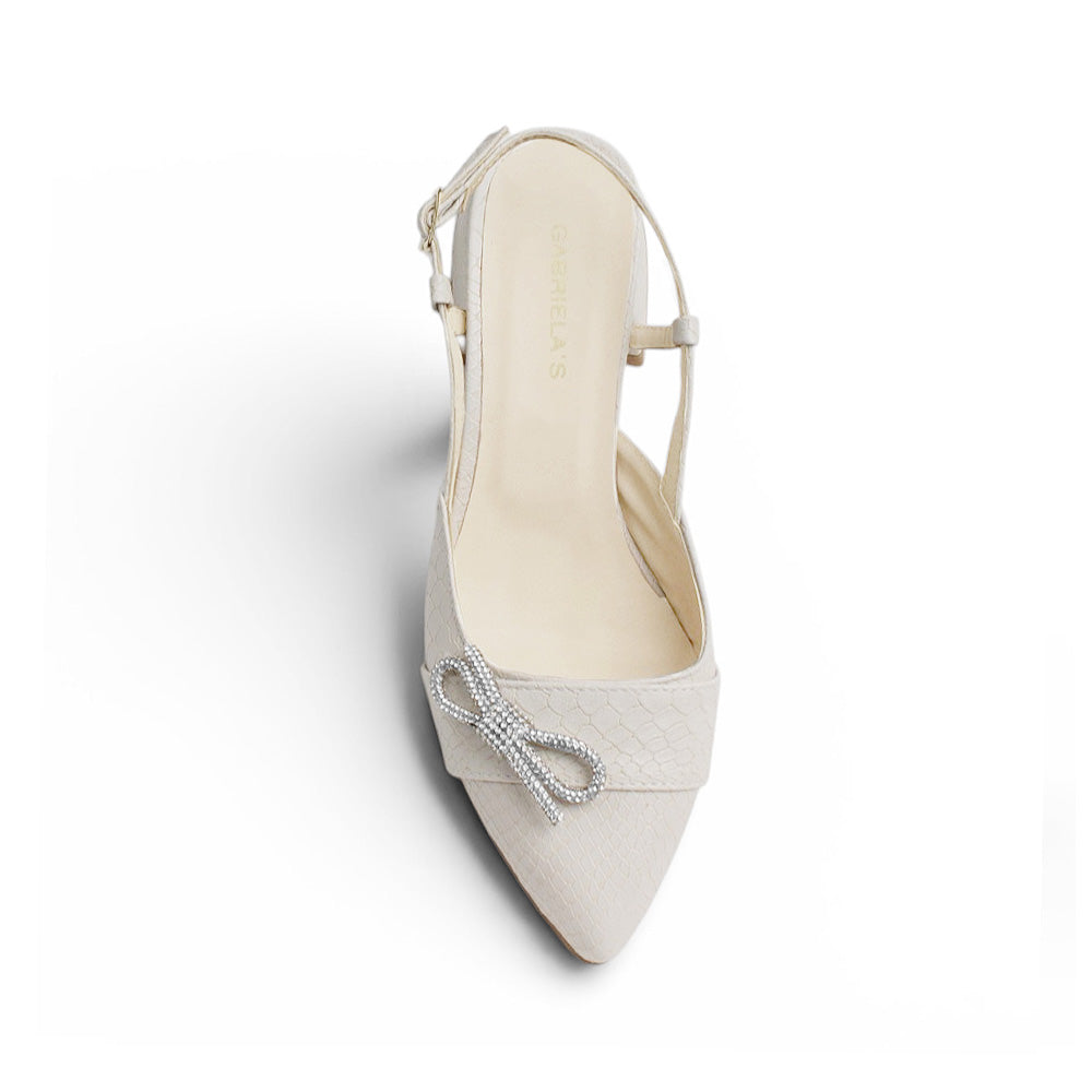 Vista superior de zapatilla destalonada para mujer con moño brilloso punta cerrada y tacón bajo de 4cm en color beige