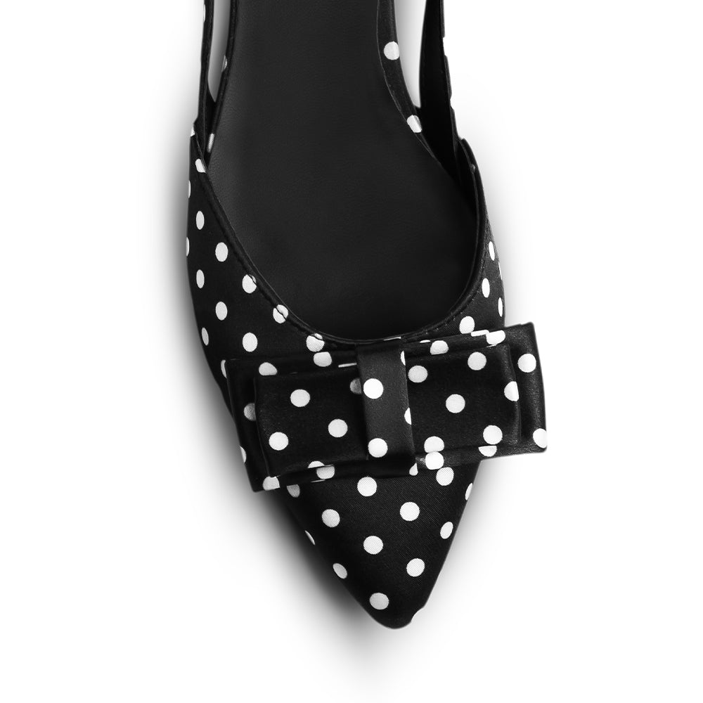 Vista del detalle en punta fina con moño decorativo de la zapatilla negra con lunares y tacón bajo 3cm para dama 