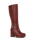 Vista diagonal de bota vino con cremallera, plataforma herraje metálico  y tacón medio 9 cm para dama 