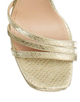 Vista de material sintético en zapatilla oro para mujer con tiras cruzadas y tacón alto de 11cm 