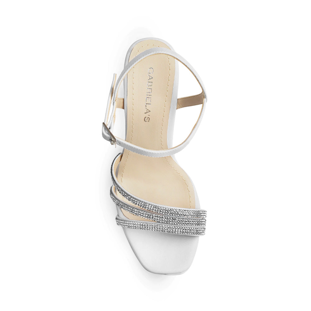Vista superior de zapatilla blanca con tiras de pedrería pulsera ajustable 
