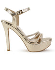 Vista lateral de zapatilla dorada para mujer con tiras de pedrería pulsera ajustable y tacón alto delgado de 13cm