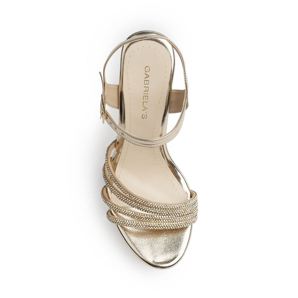 Vista superior de zapatilla dorada para mujer con tiras de pedrería pulsera ajustable al tobillo y tacón de 13cm