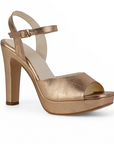 Vista diagonal de la zapatilla oro rosa con plataforma, punta abierta pulsera ajustable al tobillo y tacón alto 12cm para dama 