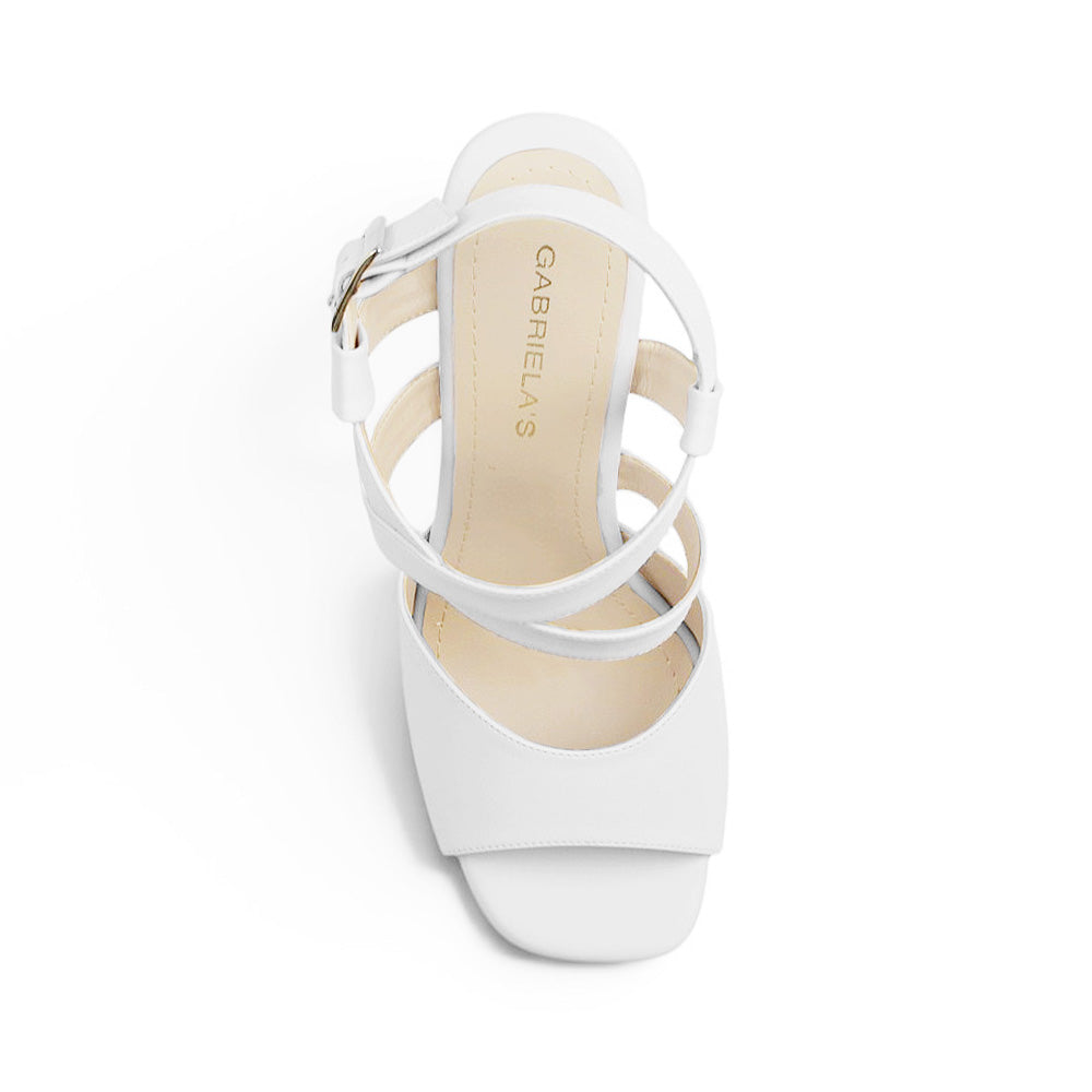 Vista superior de zapatilla de diseño descubierto con pulsera ajustable en color blanco