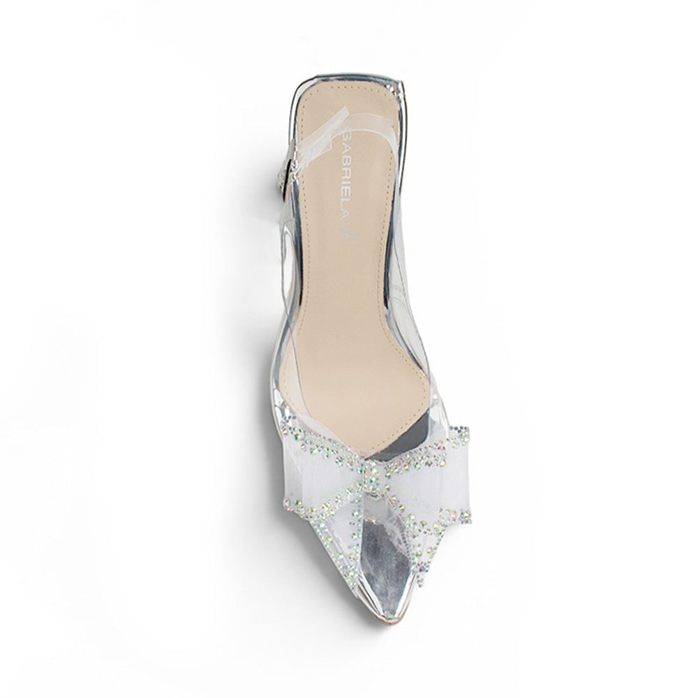 Vista superior de zapatilla plateada transparente para mujer con punta fina cerrada y moño de pedrería 