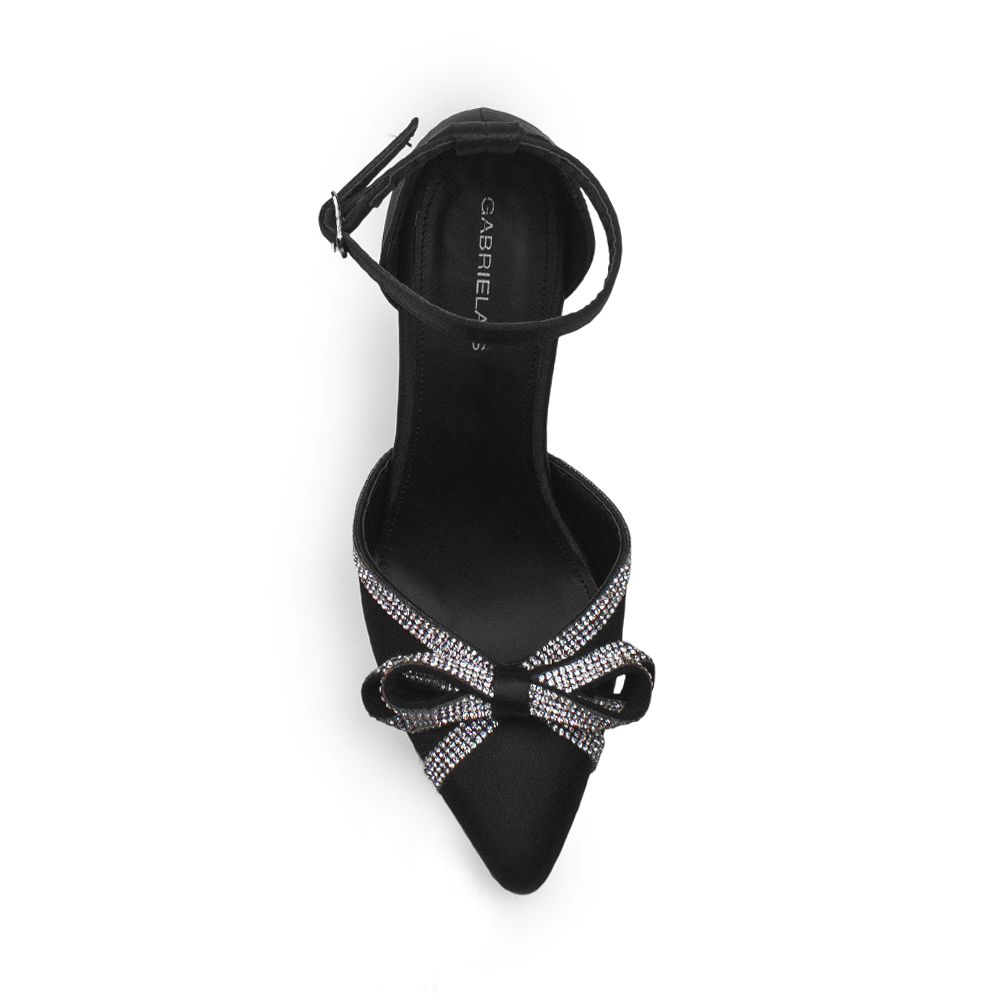 Vista superior de zapatilla negra para mujer con punta fina, moño y talón cerrado