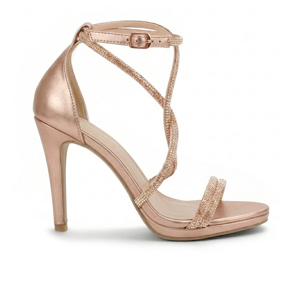 Vista lateral de zapatilla oro rosa para mujer de diseño descubierto con tiras de pedrería pulsera ajustable y tacón delgado de 10cm