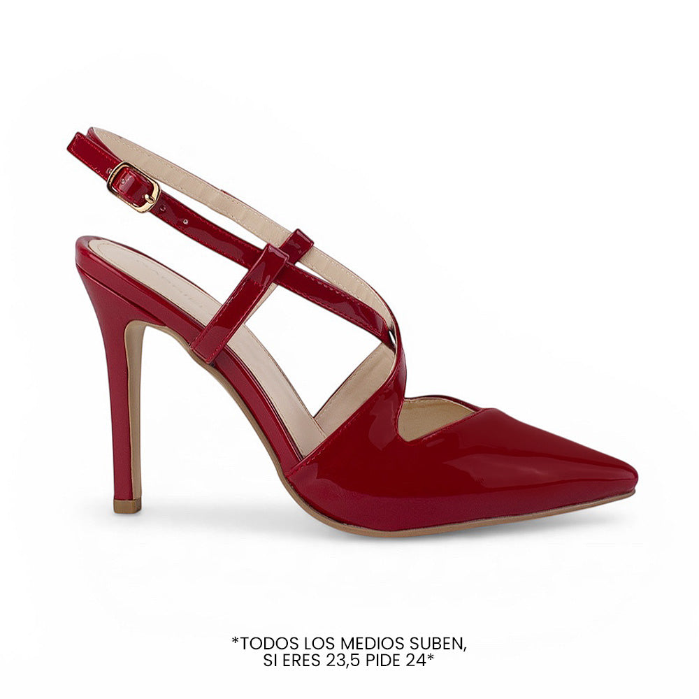 vista lateral de zapatillas stiletto rojas de charol con tiras cruzadas y tacón alto 11cm para dama