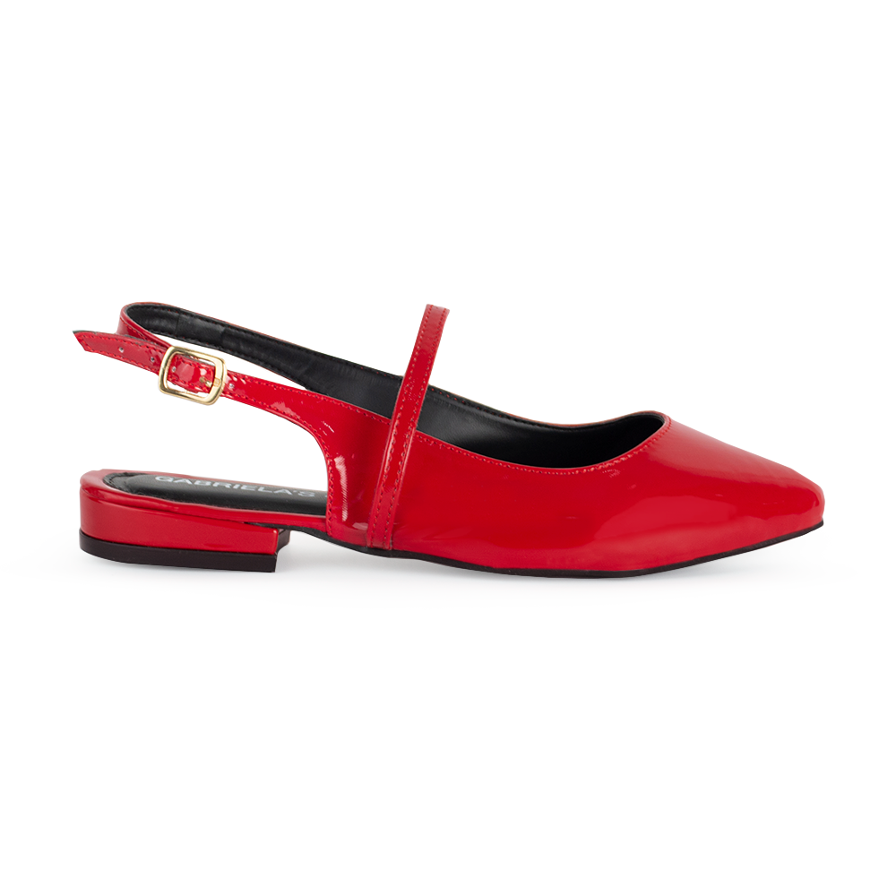 vista lateral de zapatillas rojas de charol para dama con tiras cruzadas