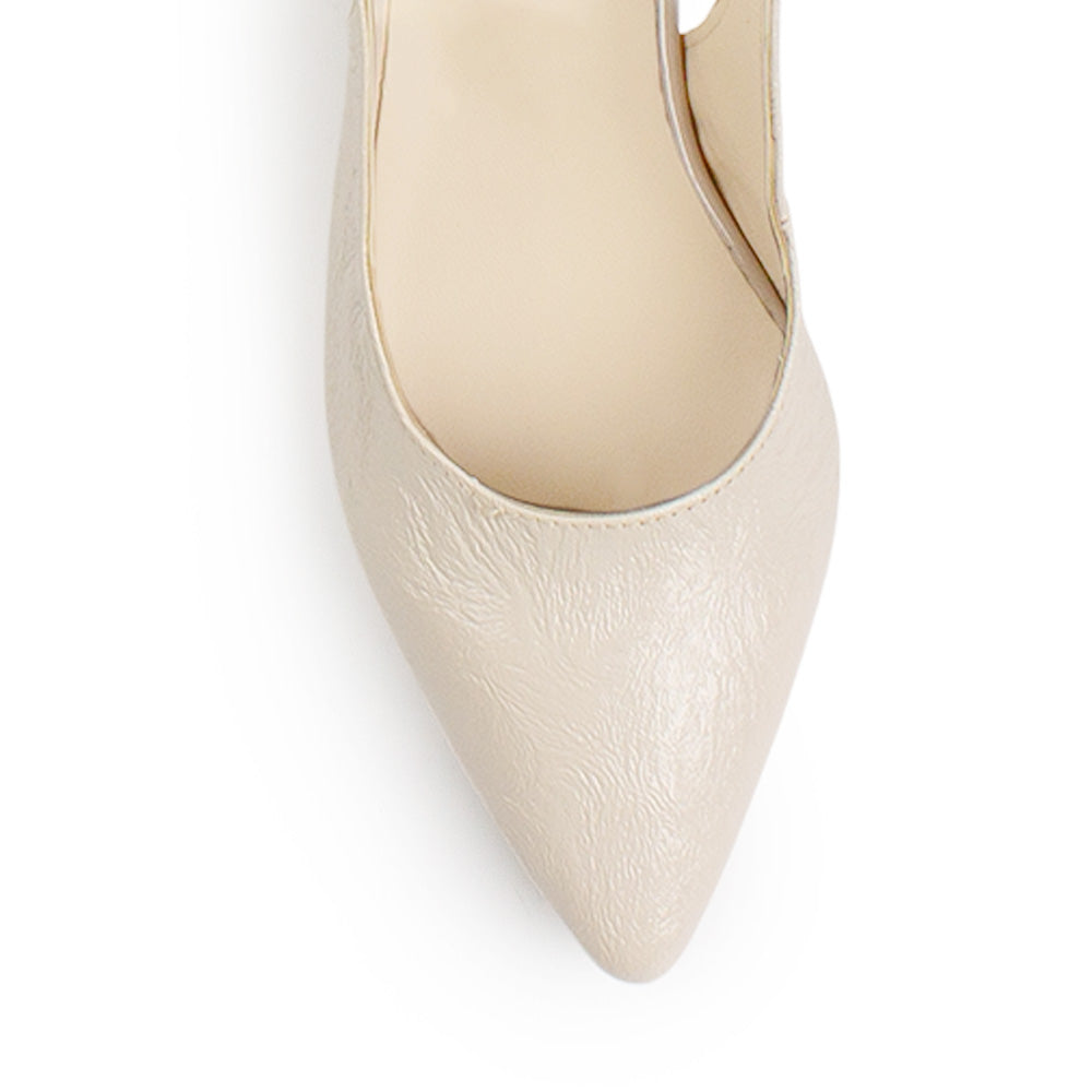 Vista de material charol en zapatilla destalonada para mujer con correa ajustable punta fina cerrada y tacón bajo cuadrado en color beige