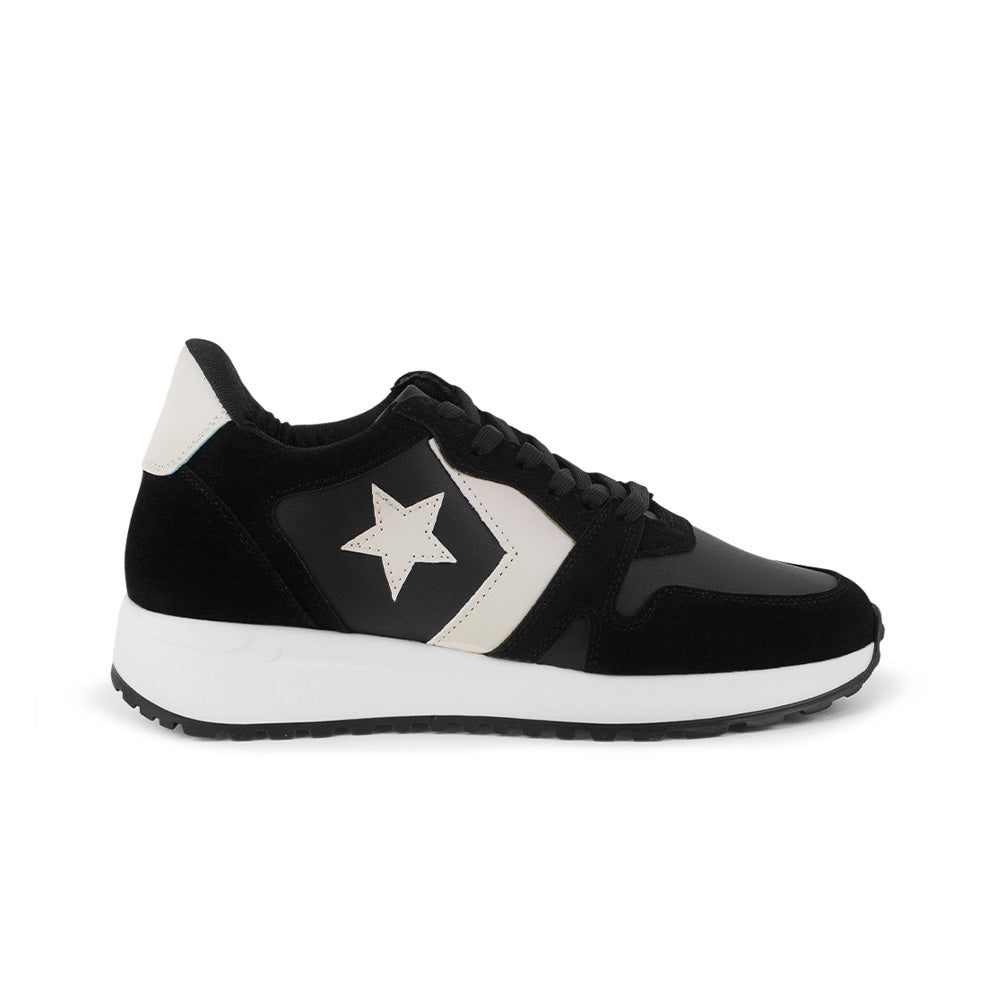 Vista lateral de tenis negro para mujer con estrellas decorativas, agujetas y plataforma baja de 4cm