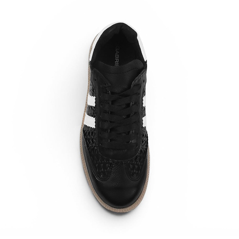 Vista superior del tenis negro con blanco para dama de piso y detalles tejidos 