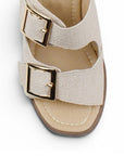Vista de material sintético en zapatilla beige para mujer con doble correa hebillas ajustables cuadradas y tacón grueso de 8cm