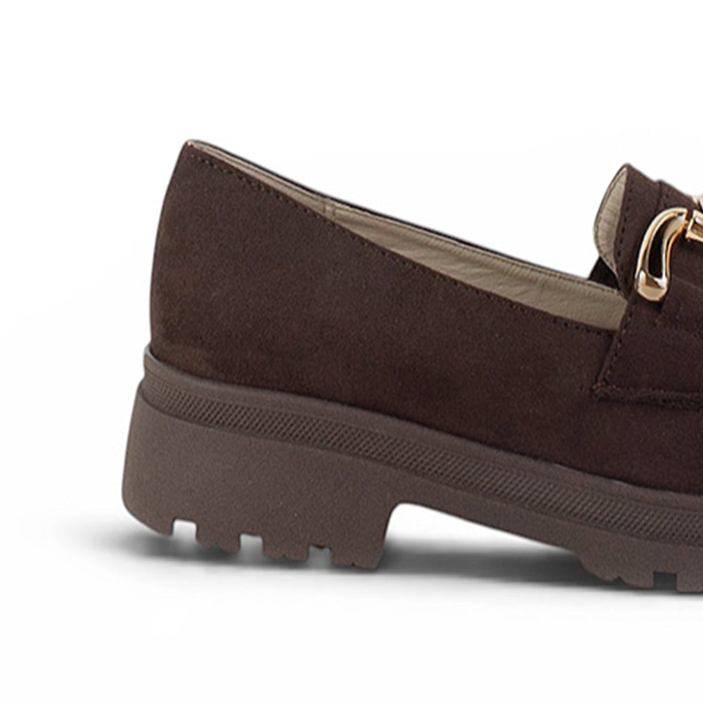 Vista trasera del tacón bajo 3cm con suela chunky tipo track del mocasín café para dama con herraje metálico decorativo 