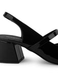 Vista trasera de tacón ancho de 6cm en zapatilla negra destalonada para mujer con moño y punta fina cerrada