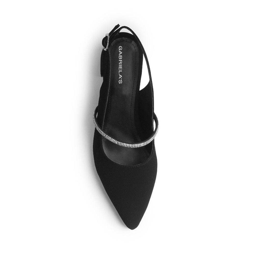 Vista superior de zapatilla negra para mujer con tira de pedrería punta fina cerrada y destalonada