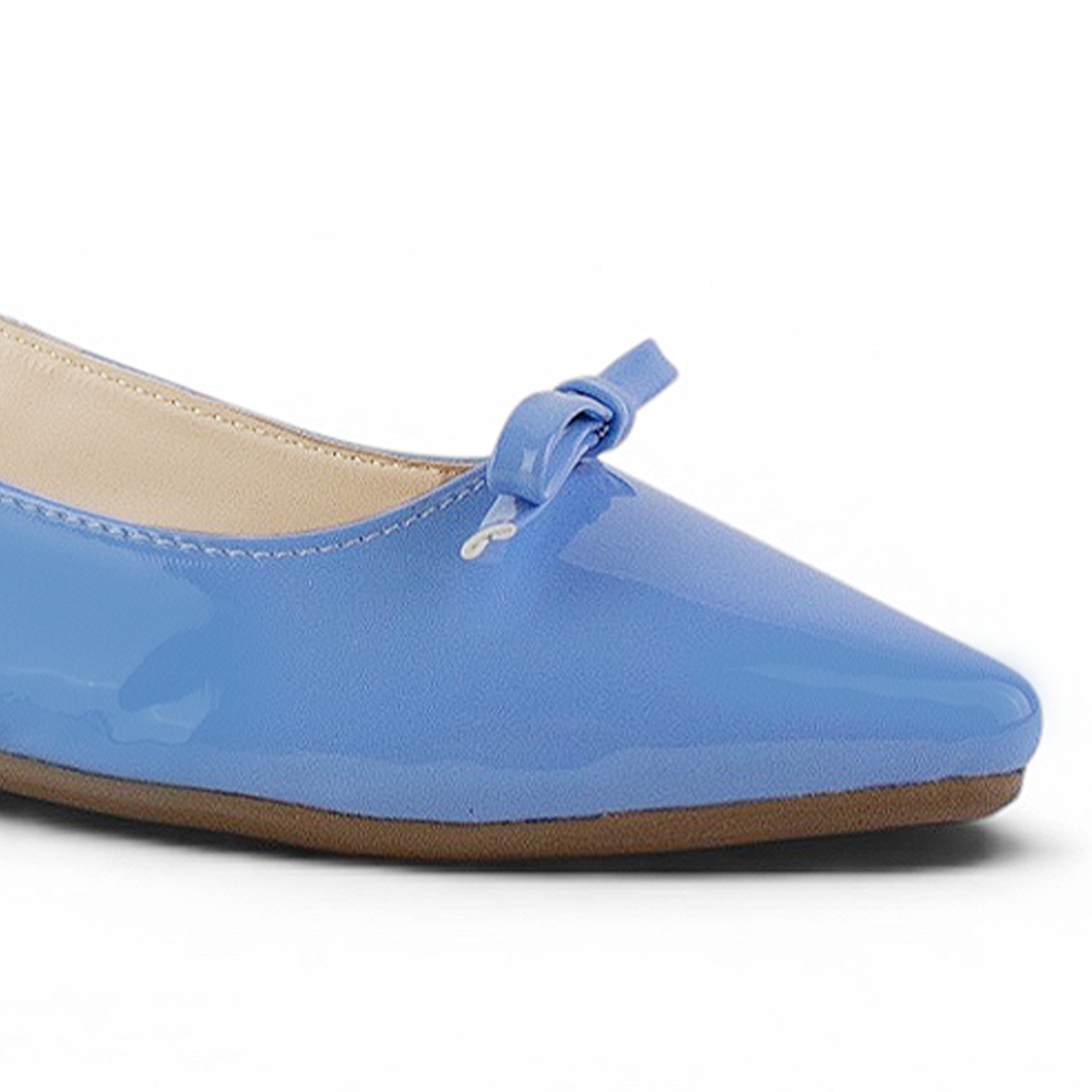 detalle del material charol en flats azules con moño de dama
