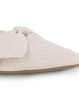 Detalle del material sintético en flats beige para dama con punta fina y moño en el empeine de piso 