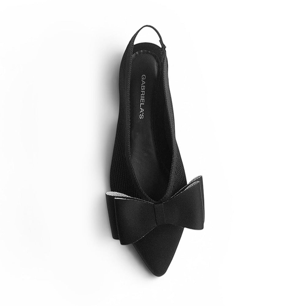 vista superior de flats negras con moño para mujer