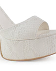 Vista a detalle de zapatilla para mujer con pulsera y tacón alto 13cm en color beige en acabado grabado 