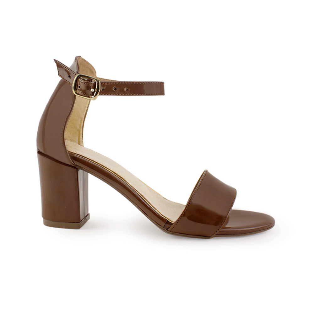 Vista lateral de zapatilla café en acabado charol para mujer con pulsera y tacón bajo