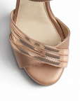 vista del detalle frontal de las zapatillas oro rosa con pulsera y plataforma de dama