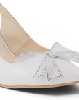 Detalle de material elegante en zapatillas beige con tacon medio para mujer